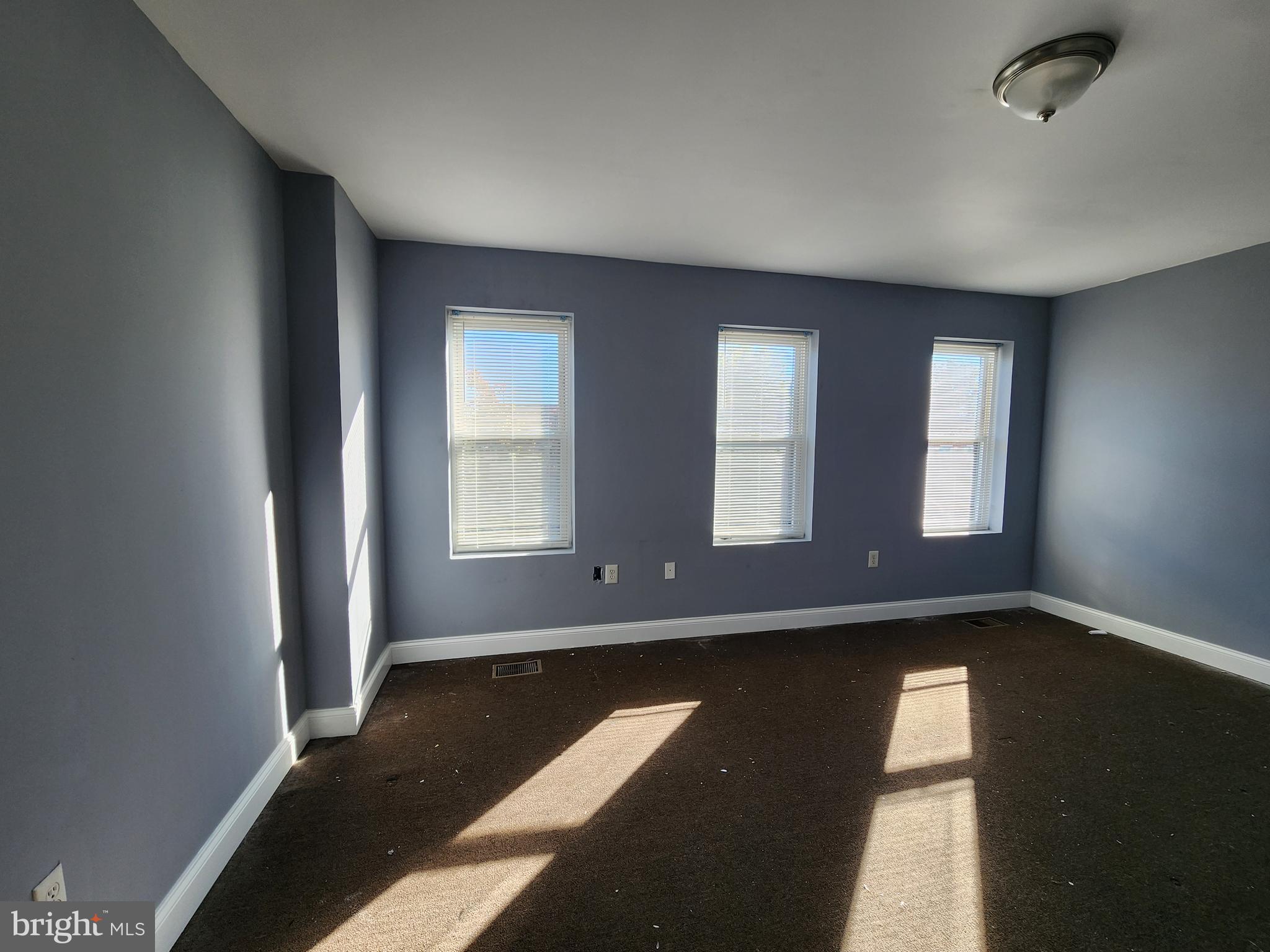 32 South Fulton Avenue Baltimore, MD 21223 - Photo 27 of 29 a view of an empty room with wooden floor and a window