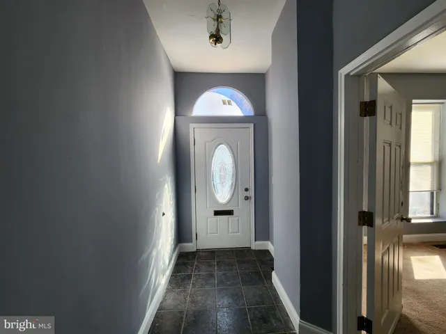 a view of a room with wooden floor mirror and windows