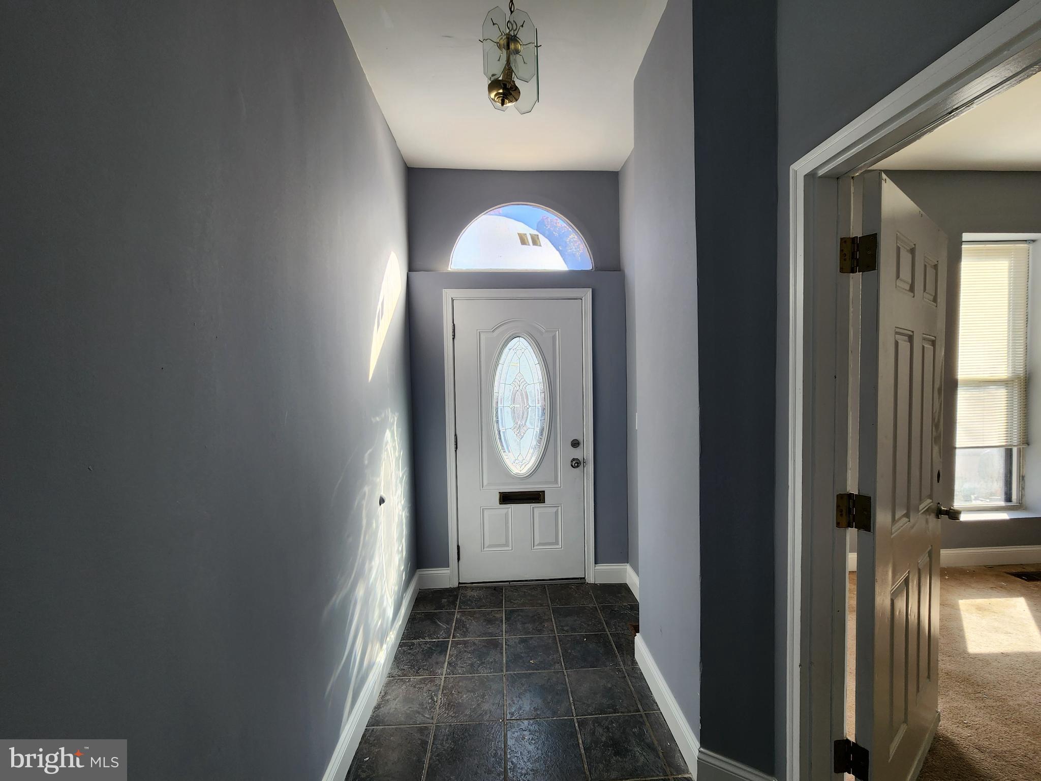32 South Fulton Avenue Baltimore, MD 21223 - Photo 3 of 29 a view of a room with wooden floor mirror and windows