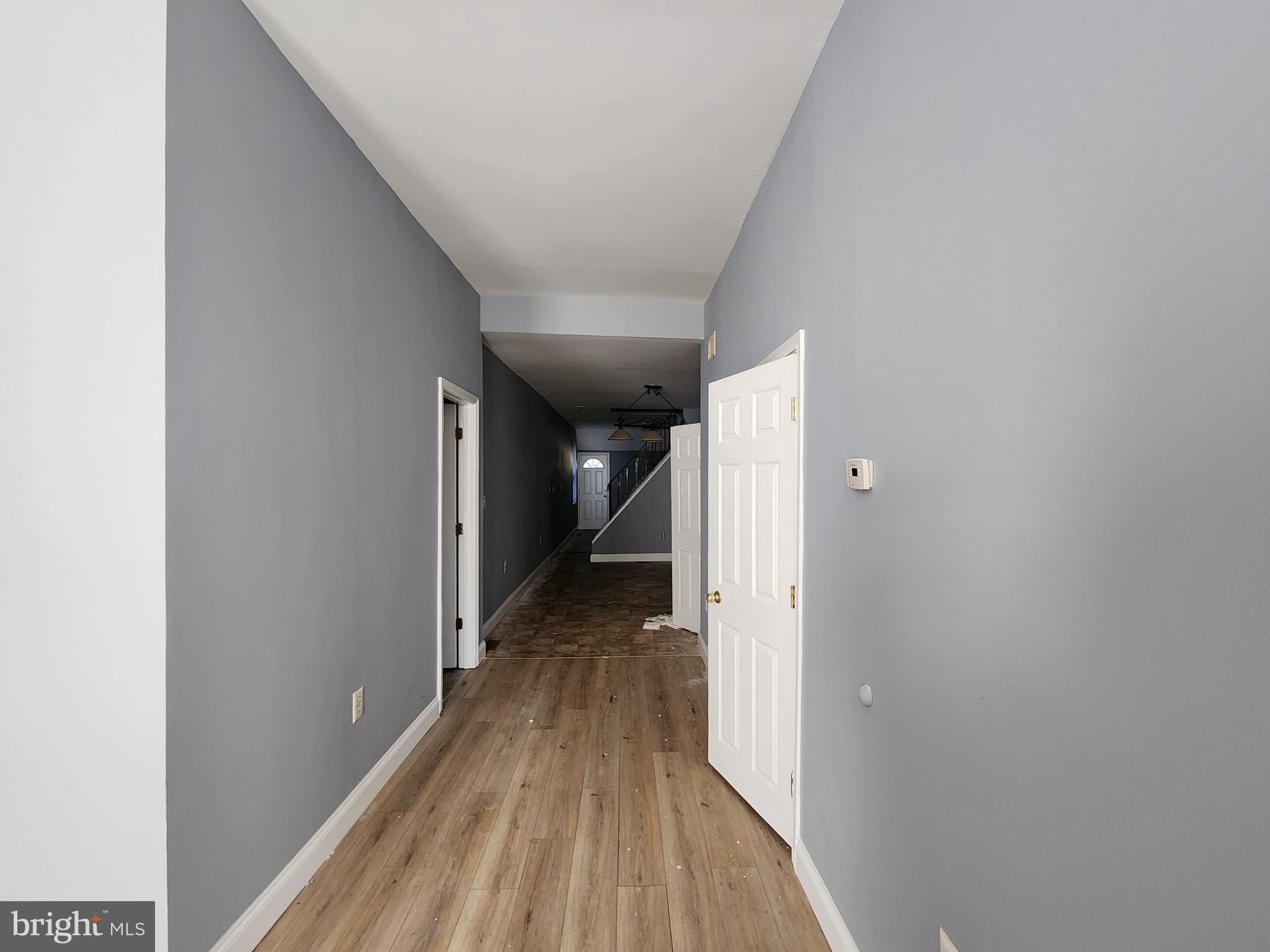 32 South Fulton Avenue Baltimore, MD 21223 - Photo 7 of 29 a view of a hallway with wooden floor