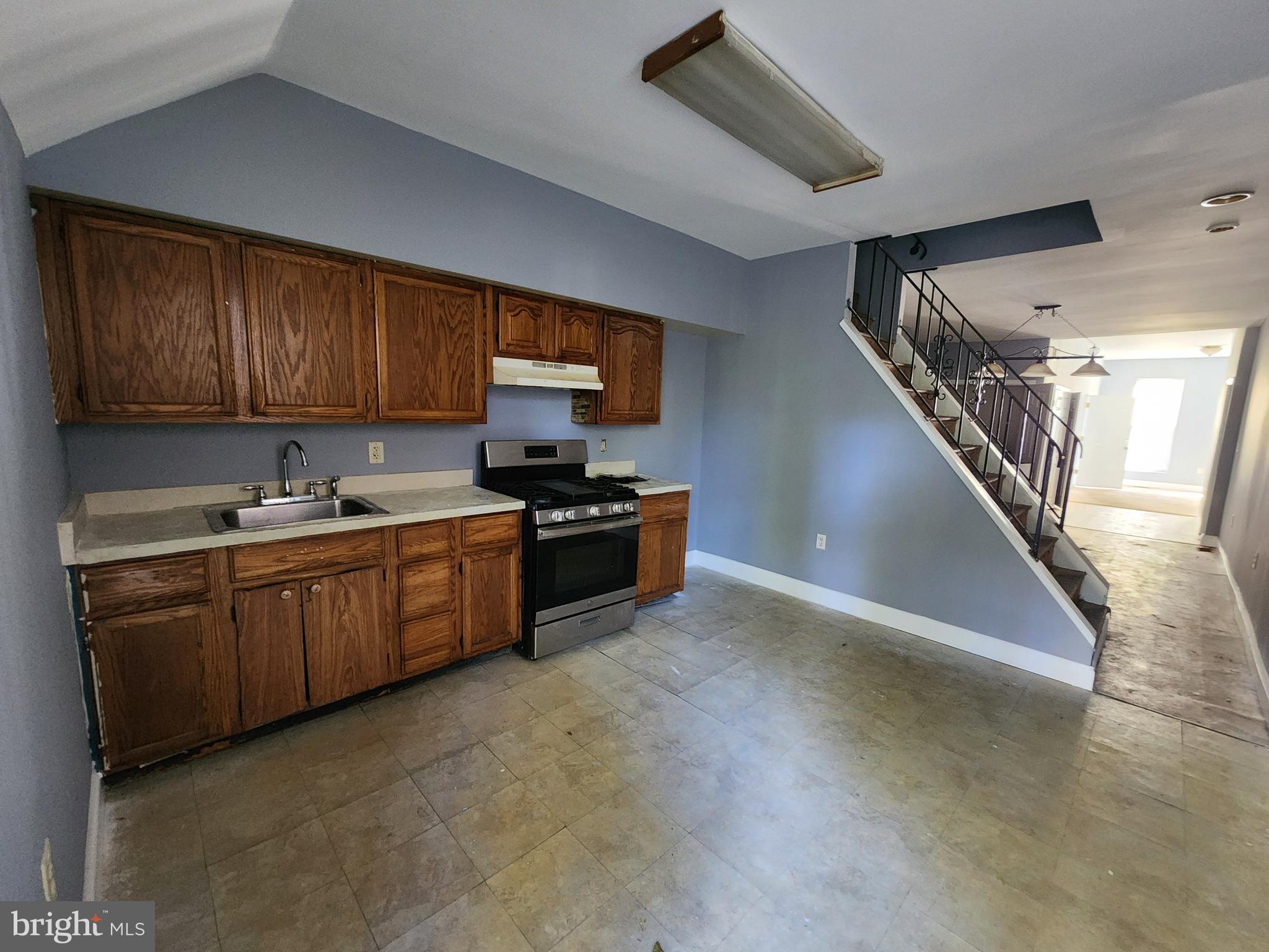 32 South Fulton Avenue Baltimore, MD 21223 - Photo 9 of 29 a kitchen with stainless steel appliances granite countertop a sink a stove top oven a chimney and cabinets