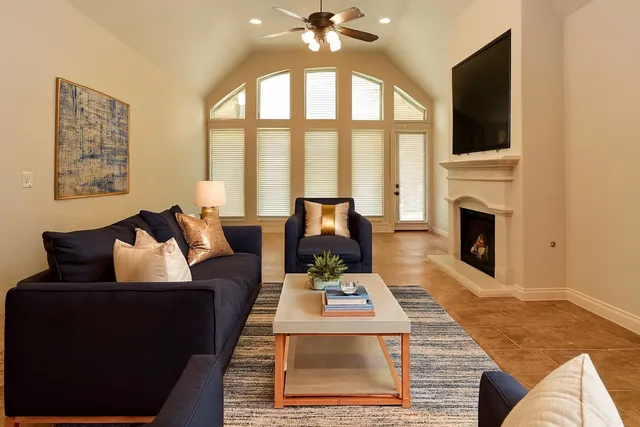 a living room with furniture fireplace and flat screen tv