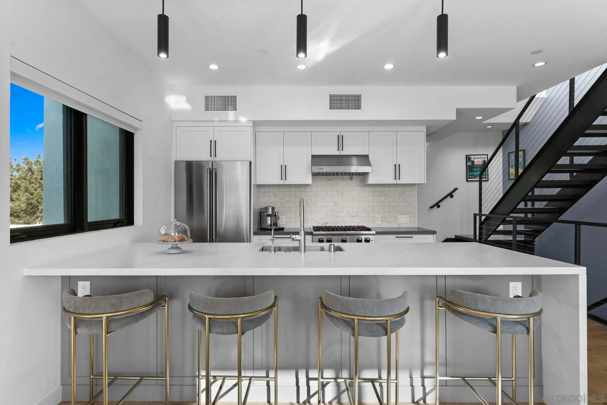 768 North Coast Highway 101 Encinitas, CA 92024 - Photo 16 of 68 a kitchen with stainless steel appliances granite countertop a table chairs sink and cabinets