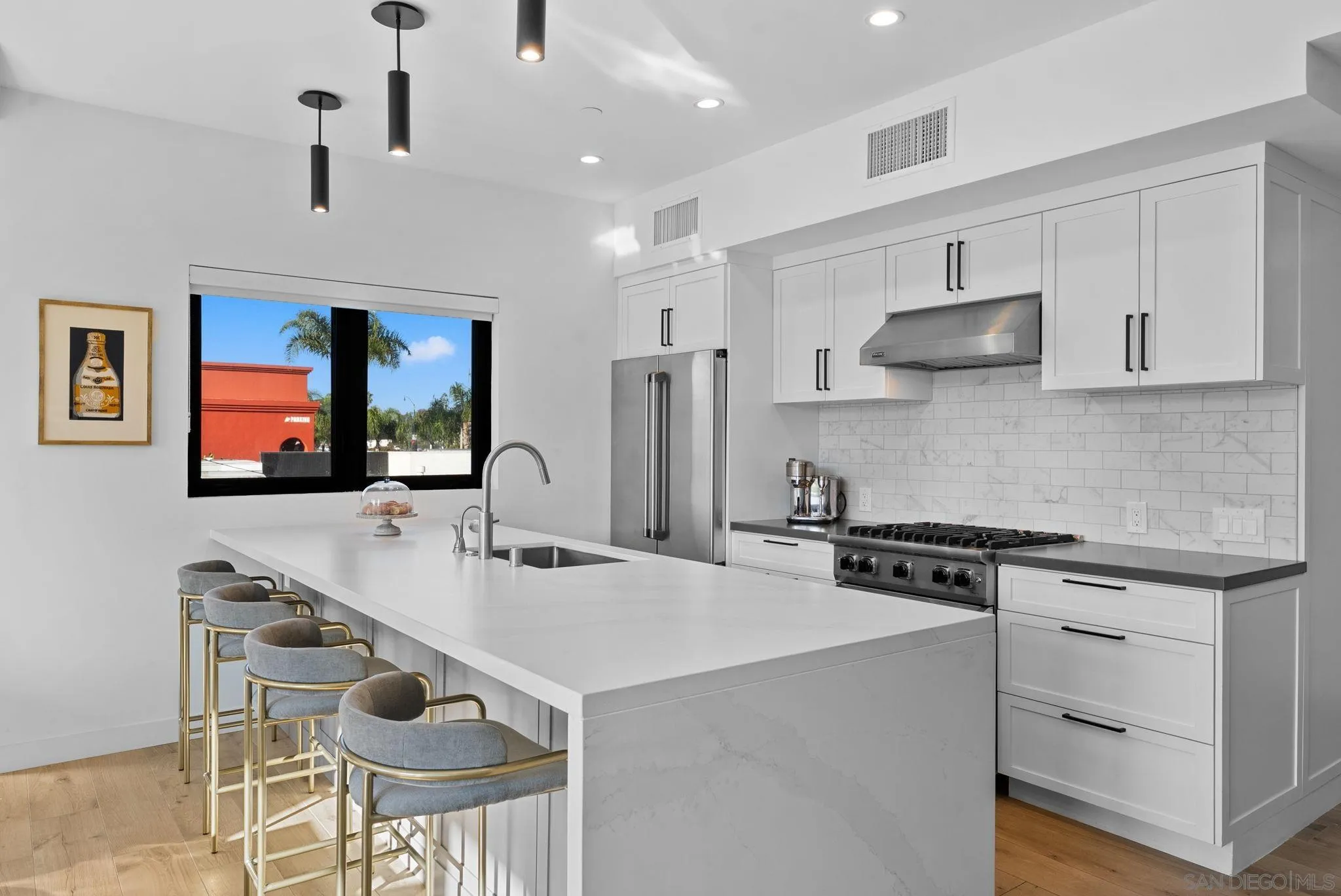 768 North Coast Highway 101 Encinitas, CA 92024 - Photo 17 of 68 a kitchen with stainless steel appliances a stove a sink a microwave a refrigerator and chairs