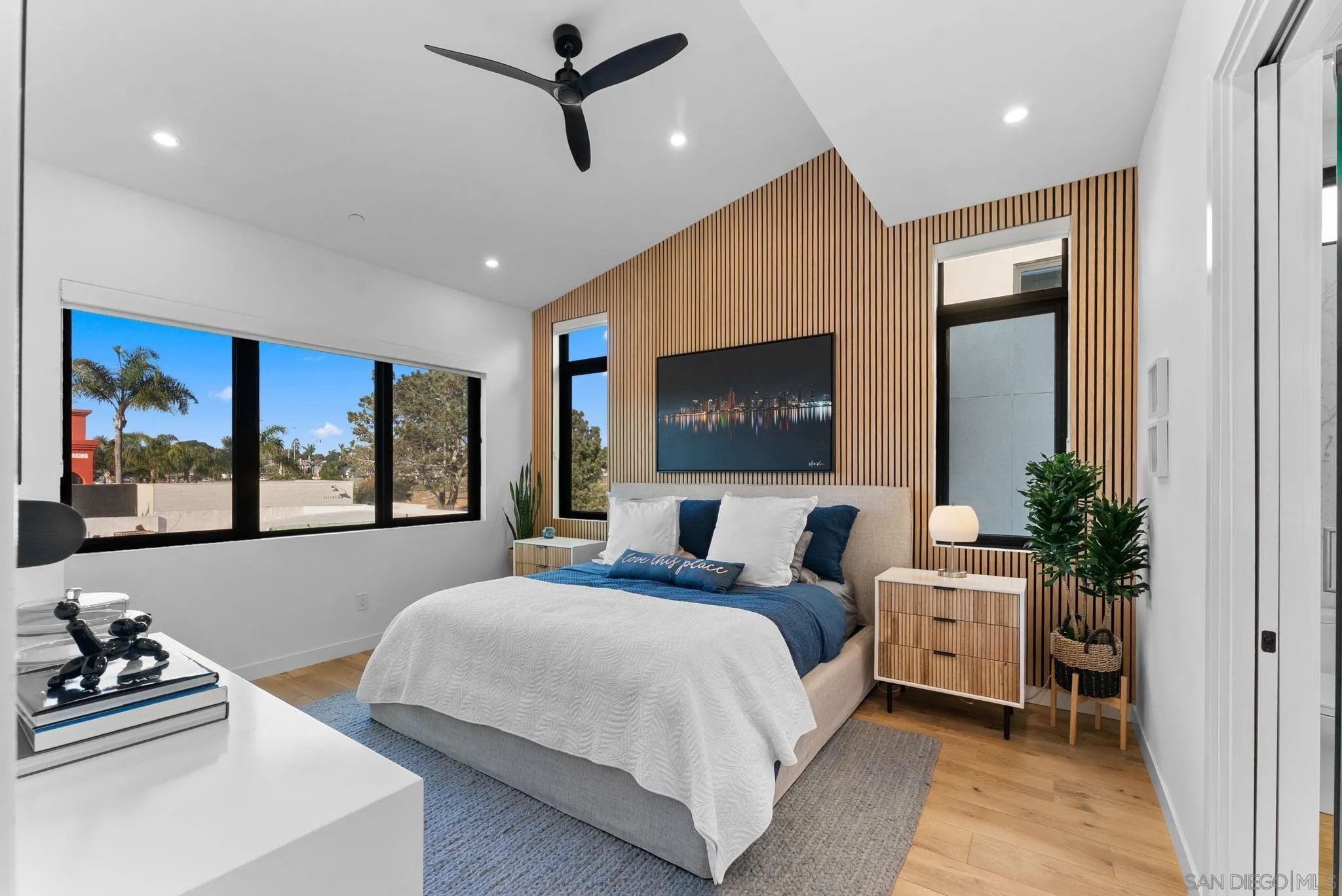 768 North Coast Highway 101 Encinitas, CA 92024 - Photo 33 of 68 a bedroom with a bed a dresser and a flat screen tv