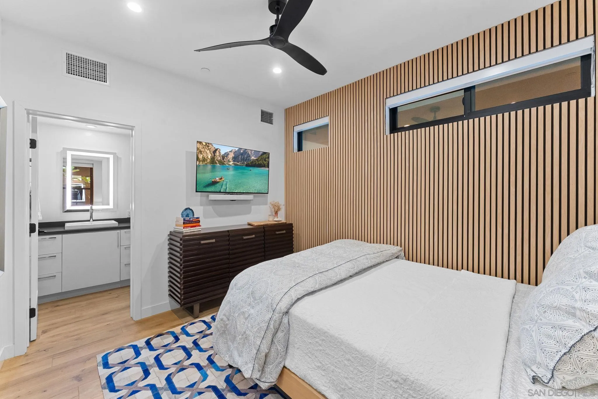 768 North Coast Highway 101 Encinitas, CA 92024 - Photo 39 of 68 a bedroom with a bed and a chandelier