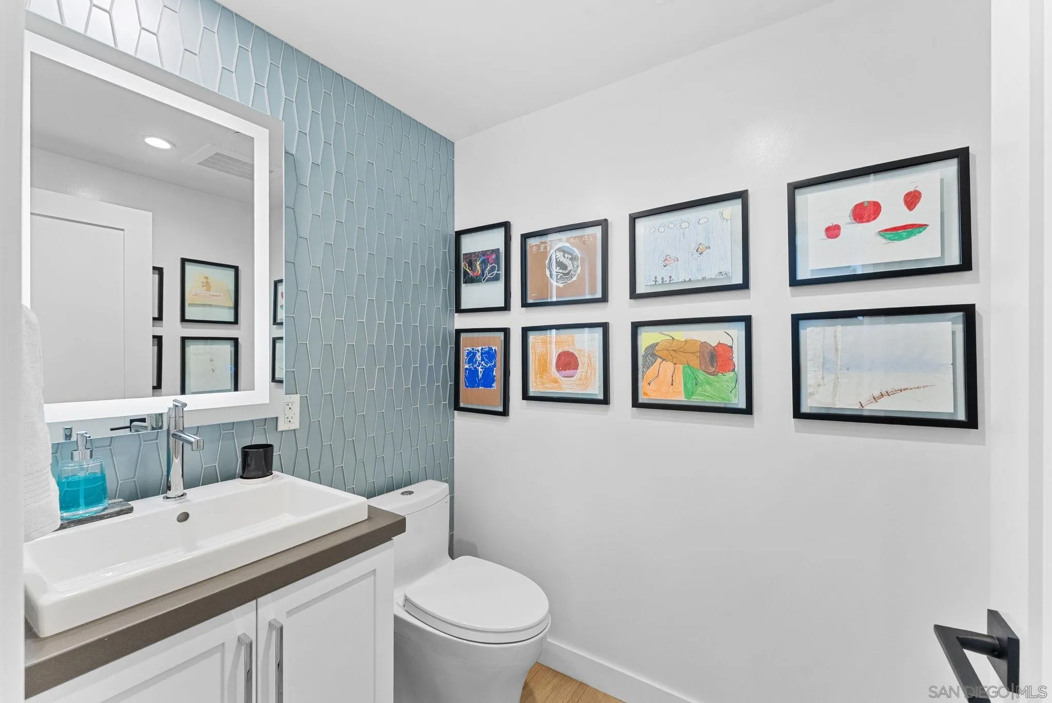 768 North Coast Highway 101 Encinitas, CA 92024 - Photo 41 of 68 a bathroom with a toilet a sink and a mirror