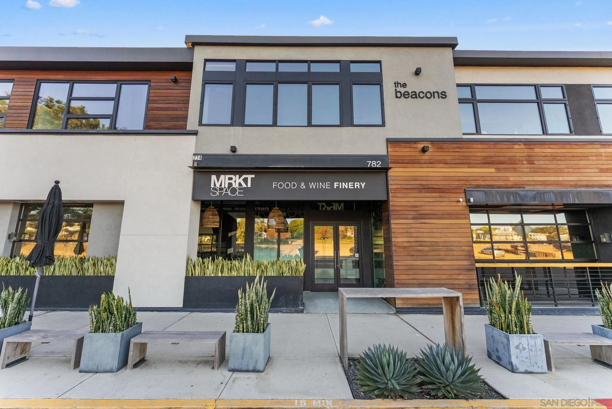 768 North Coast Highway 101 Encinitas, CA 92024 - Photo 47 of 68 a front view of a building with outdoor shower and plants