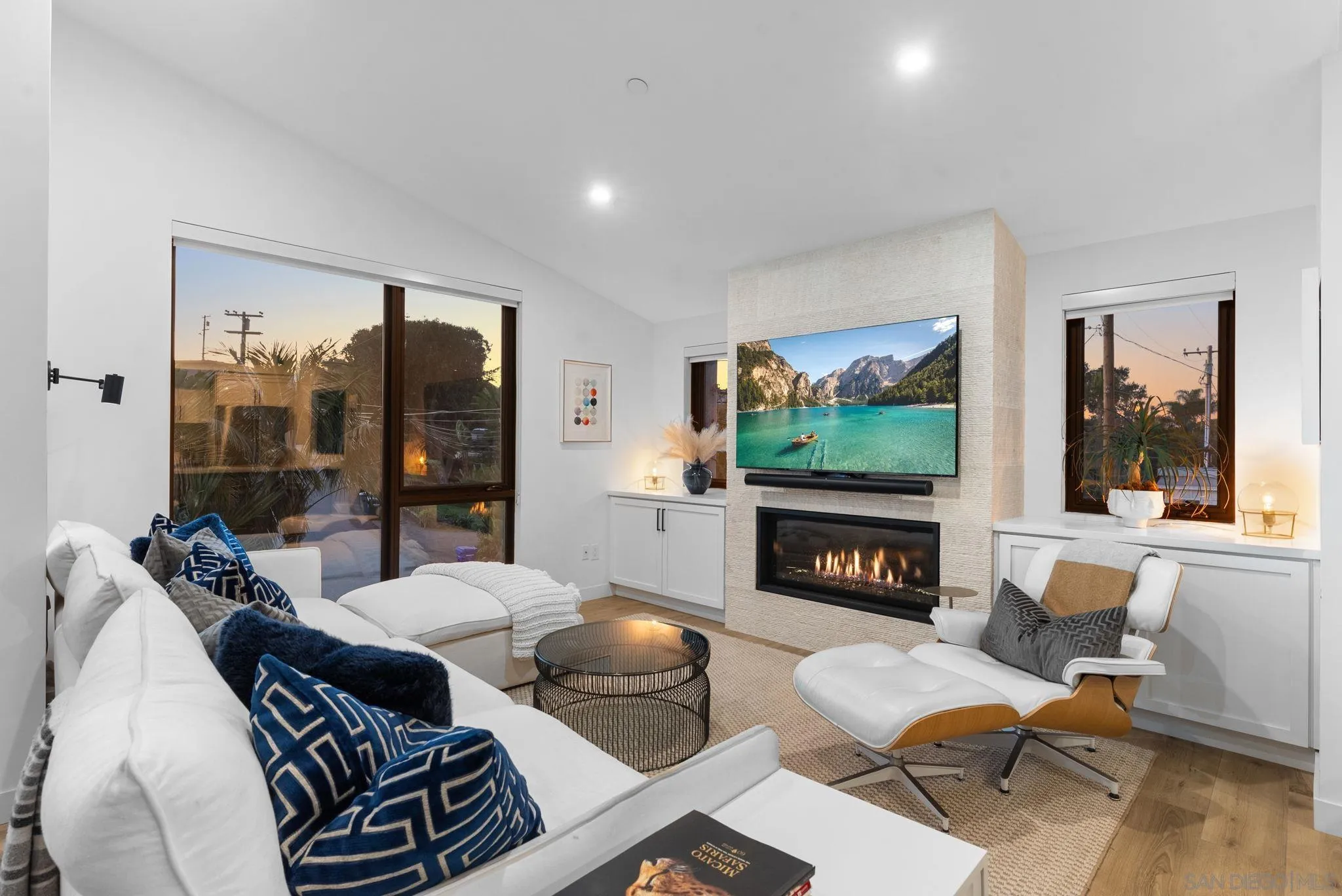768 North Coast Highway 101 Encinitas, CA 92024 - Photo 9 of 68 a living room with furniture a flat screen tv and a floor to ceiling window
