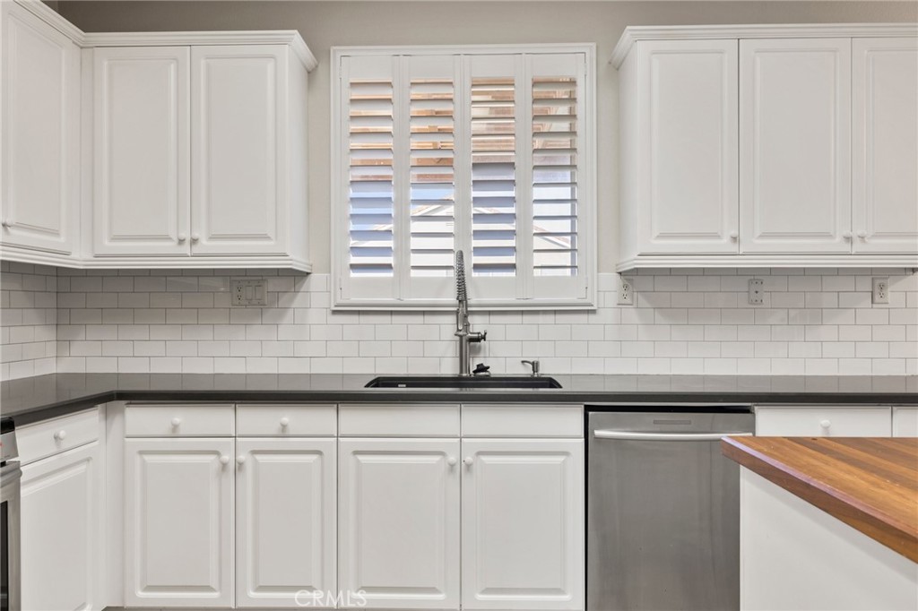 46221 Jane Place Temecula, CA 92592 - Photo 11 of 41 a kitchen with granite countertop white cabinets and a window