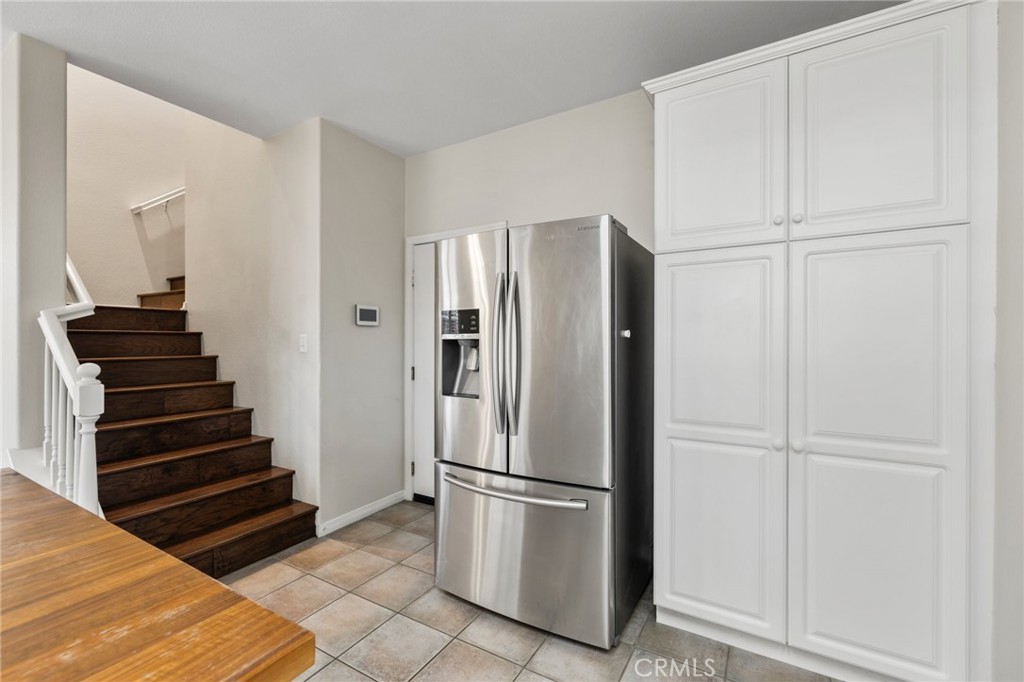 46221 Jane Place Temecula, CA 92592 - Photo 13 of 41 a view of kitchen with refrigerator and wooden cabinets