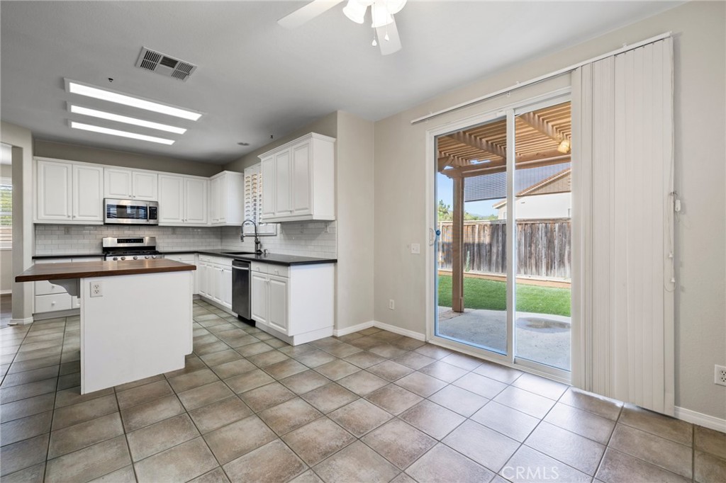 46221 Jane Place Temecula, CA 92592 - Photo 15 of 41 a kitchen with white cabinets and appliances