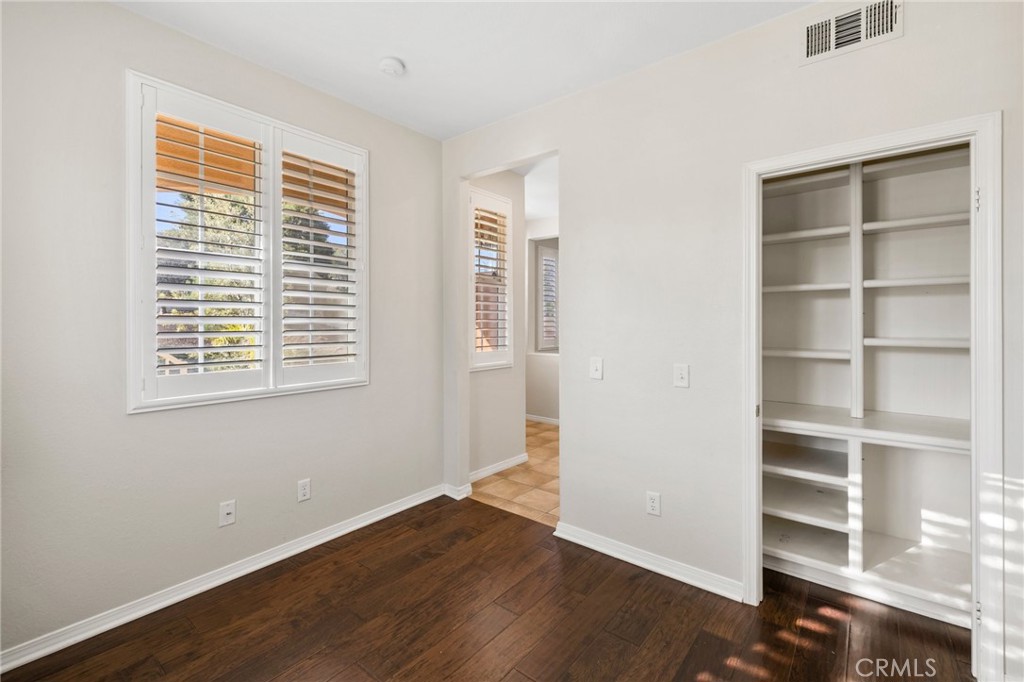46221 Jane Place Temecula, CA 92592 - Photo 17 of 41 a view of an empty room with a window and wooden floor