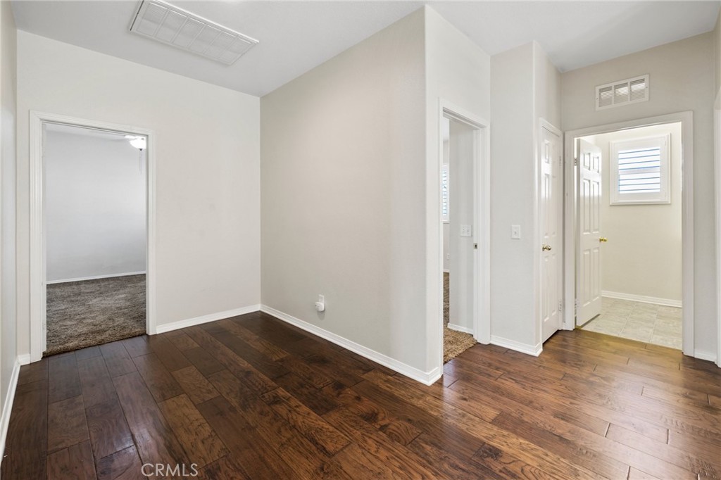 46221 Jane Place Temecula, CA 92592 - Photo 19 of 41 an empty room with wooden floor & windows