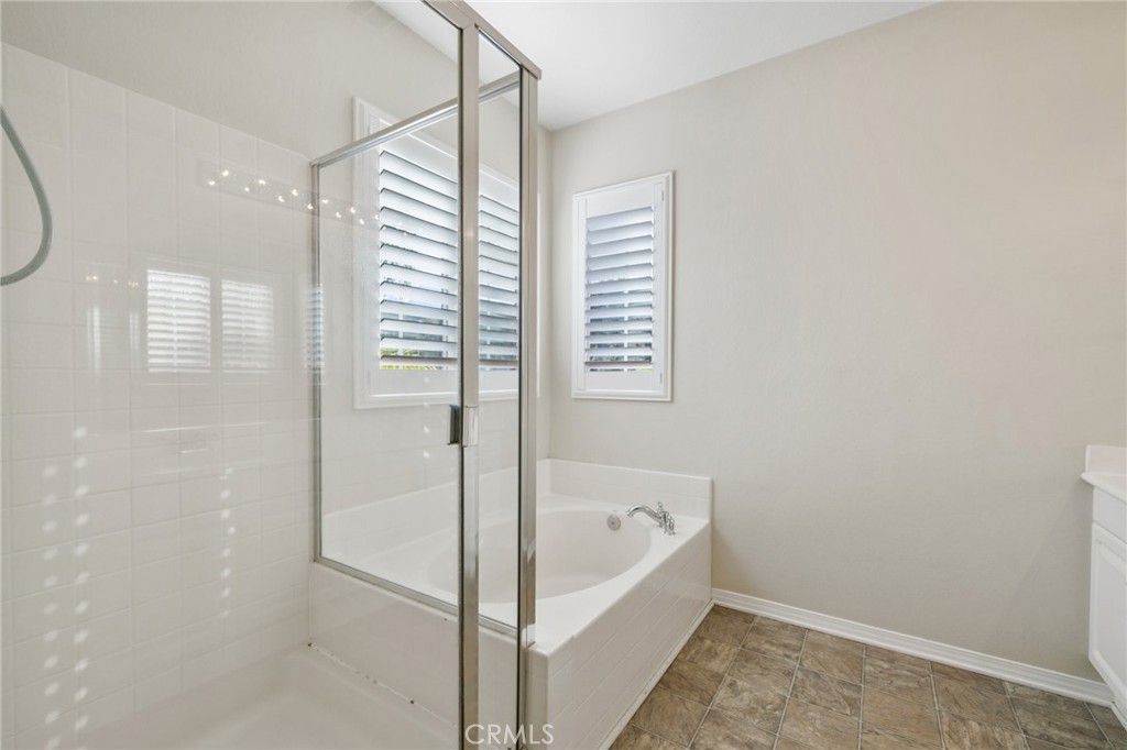 46221 Jane Place Temecula, CA 92592 - Photo 23 of 41 a bathroom with a bathtub and a shower