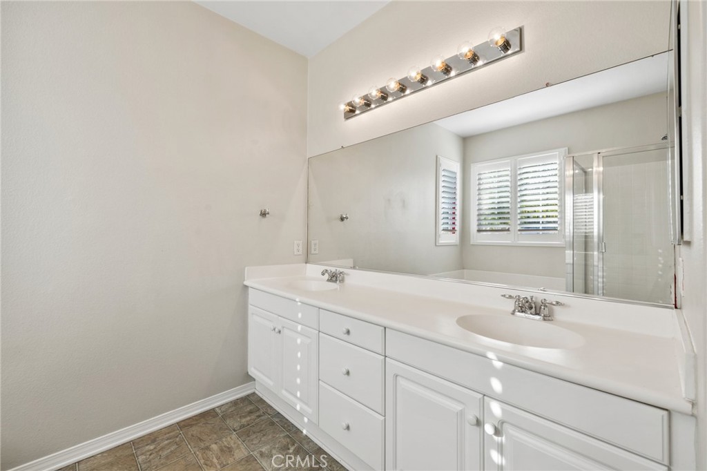 46221 Jane Place Temecula, CA 92592 - Photo 24 of 41 a bathroom with a double vanity sink and a mirror