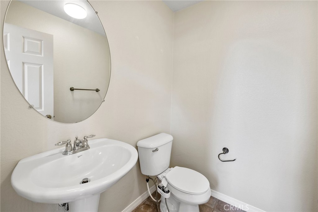 46221 Jane Place Temecula, CA 92592 - Photo 28 of 41 a bathroom with a sink a mirror and a toilet