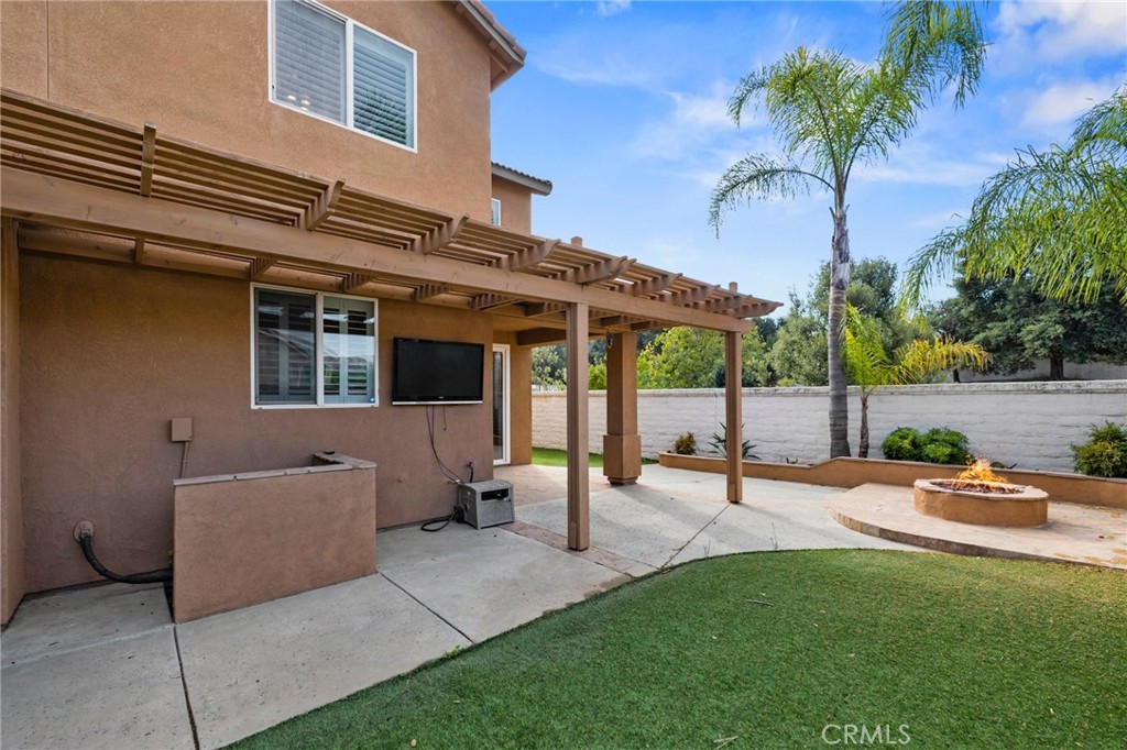 46221 Jane Place Temecula, CA 92592 - Photo 32 of 41 a view of a patio with table and chairs potted plants and palm tree