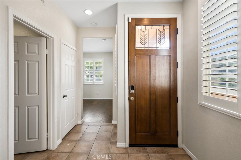 46221 Jane Place Temecula, CA 92592 - Photo 5 of 41 a view of a hallway with wooden floor and a bathroom