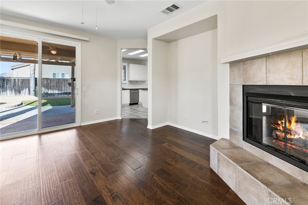 46221 Jane Place Temecula, CA 92592 - Photo 6 of 41 a view of an empty room with wooden floor and a fireplace