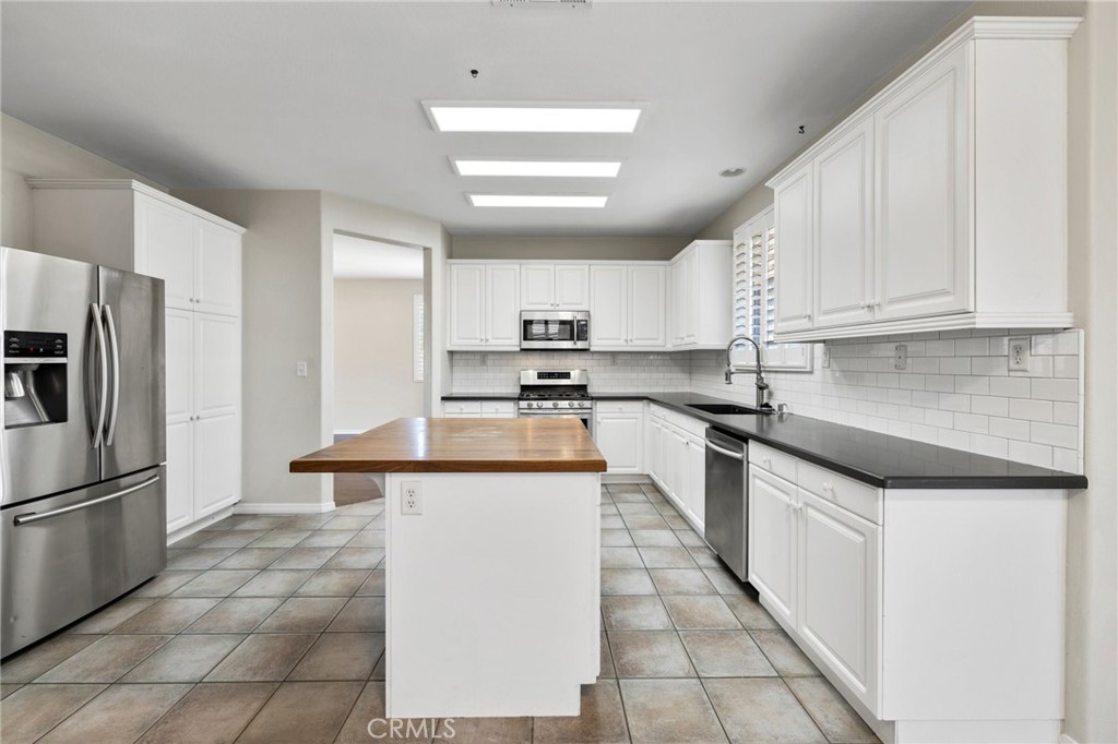 46221 Jane Place Temecula, CA 92592 - Photo 8 of 41 a kitchen with stainless steel appliances granite countertop a sink stove refrigerator and cabinets