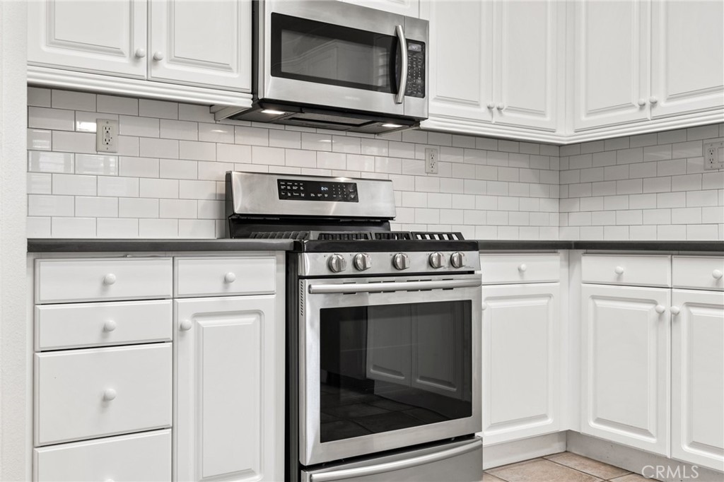 46221 Jane Place Temecula, CA 92592 - Photo 10 of 41 a kitchen with stainless steel appliances granite countertop white cabinets a stove a sink and dishwasher