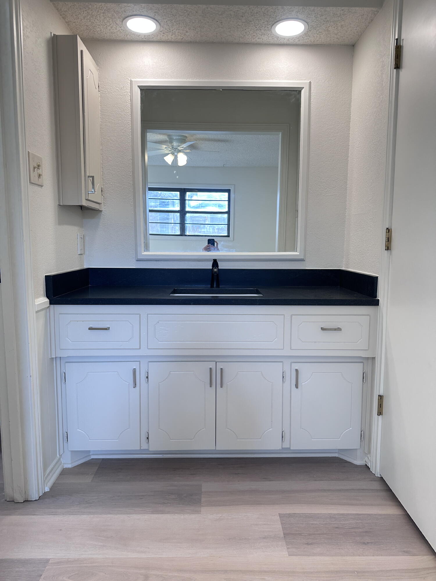 2217 33rd Street, Unit B Lubbock, TX 79411 - Photo 11 of 14 a view of a kitchen with white cabinets