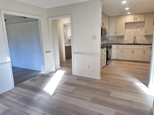 a view of a kitchen cabinets and wooden floor