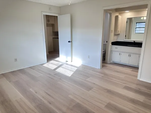 a view of a kitchen from a hallway
