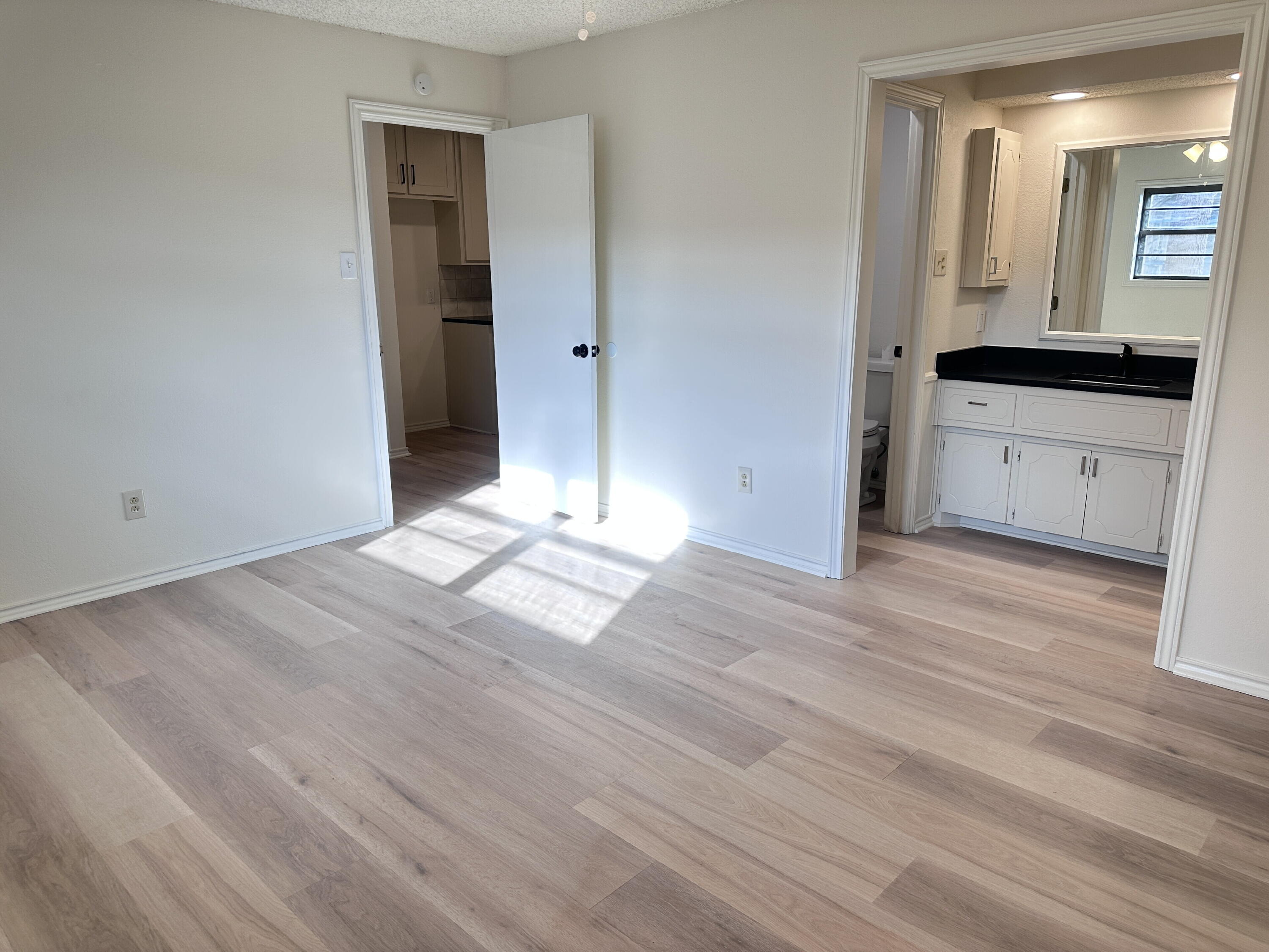 2217 33rd Street, Unit B Lubbock, TX 79411 - Photo 9 of 14 a view of a kitchen from a hallway