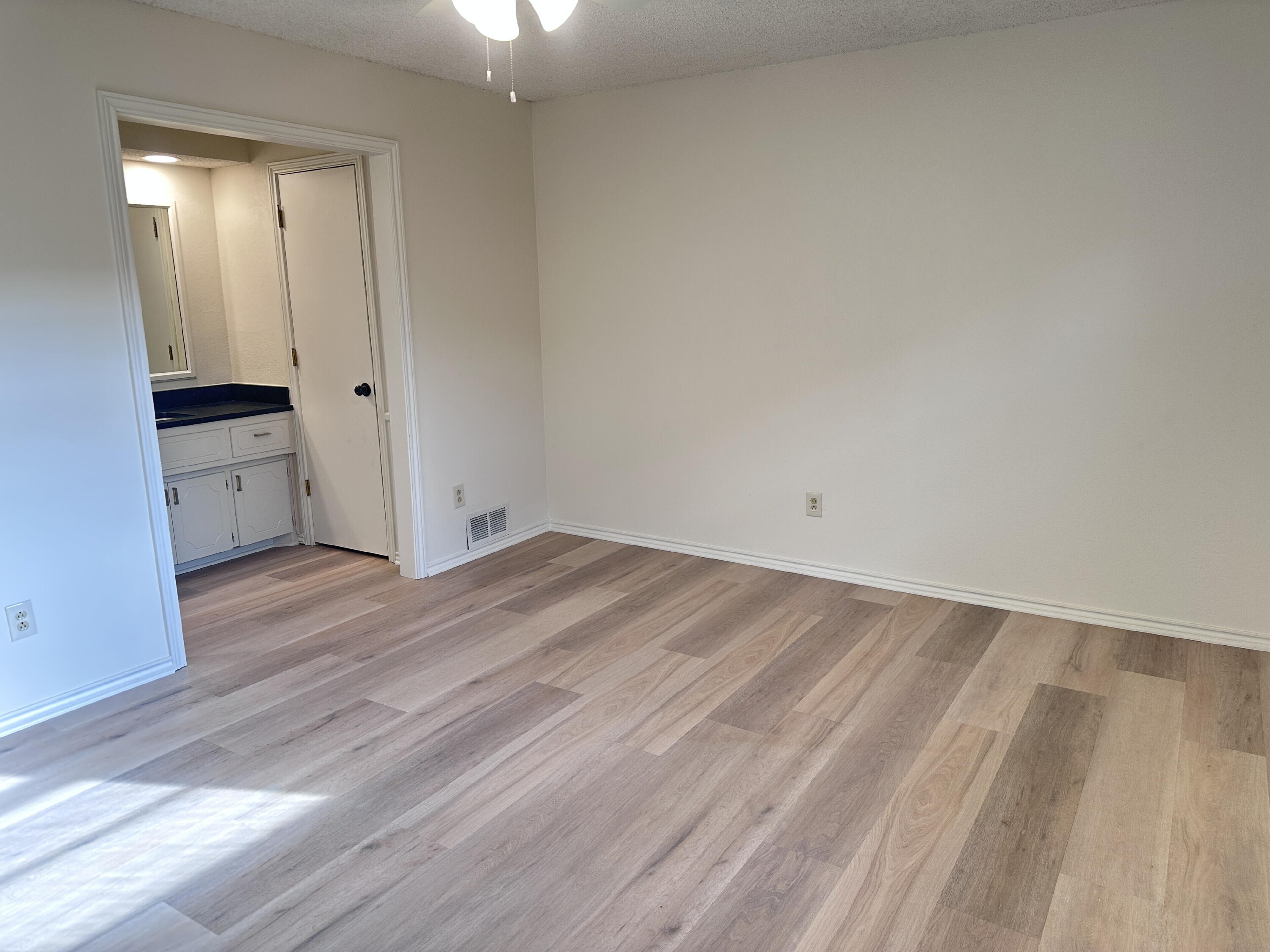 2217 33rd Street, Unit B Lubbock, TX 79411 - Photo 10 of 14 wooden floor in an empty room
