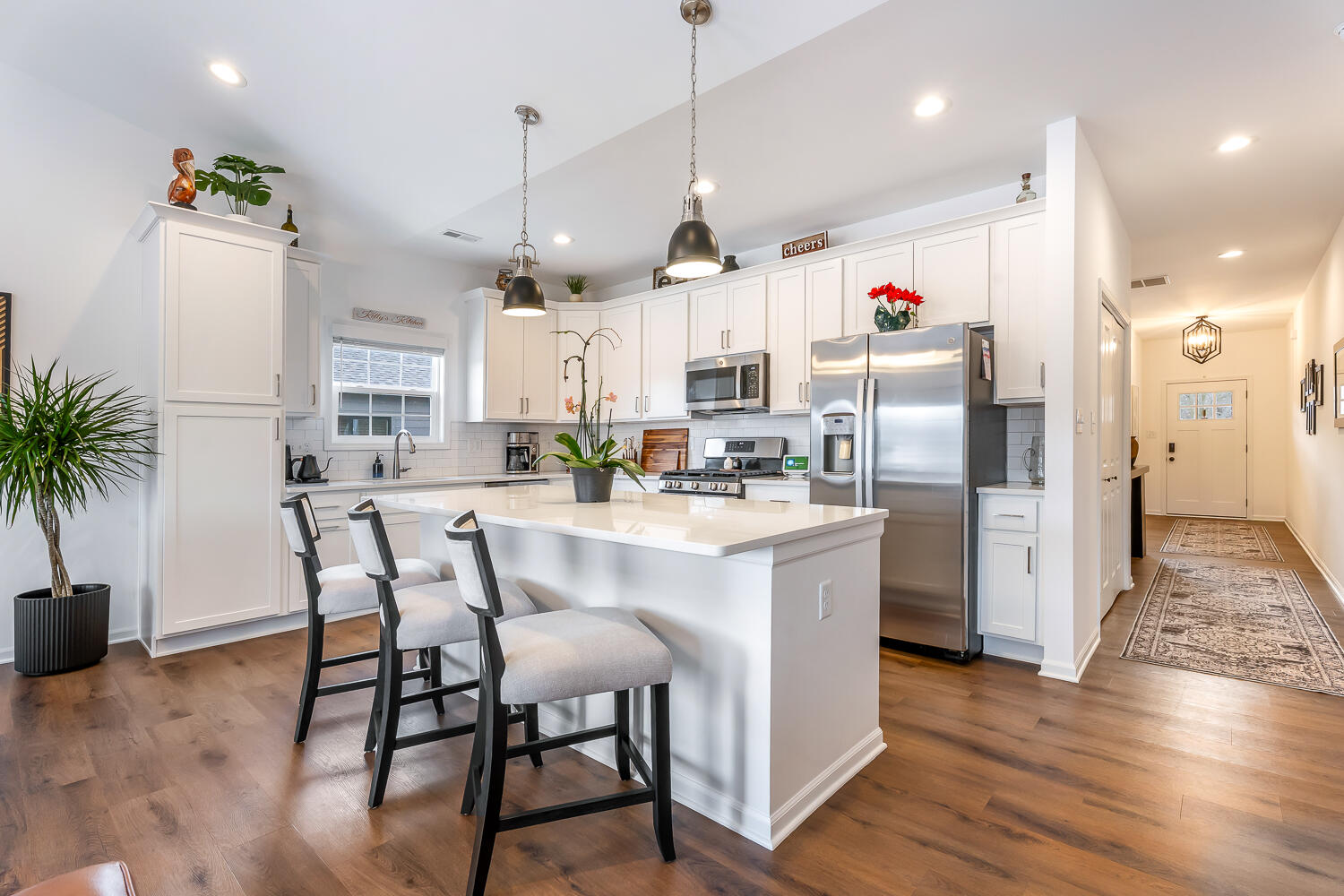 709 Verdano Terrace Crown Point, IN 46307 - Photo 18 of 39 a kitchen with stainless steel appliances kitchen island granite countertop a refrigerator a stove and white cabinets with wooden floor