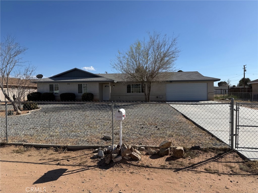 22031 Isatis Avenue Apple Valley, CA 92307 - Photo 1 of 1 a front view of a house with trees