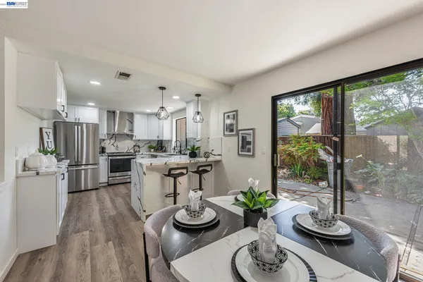 a view of a hallway with wooden floor and stairs