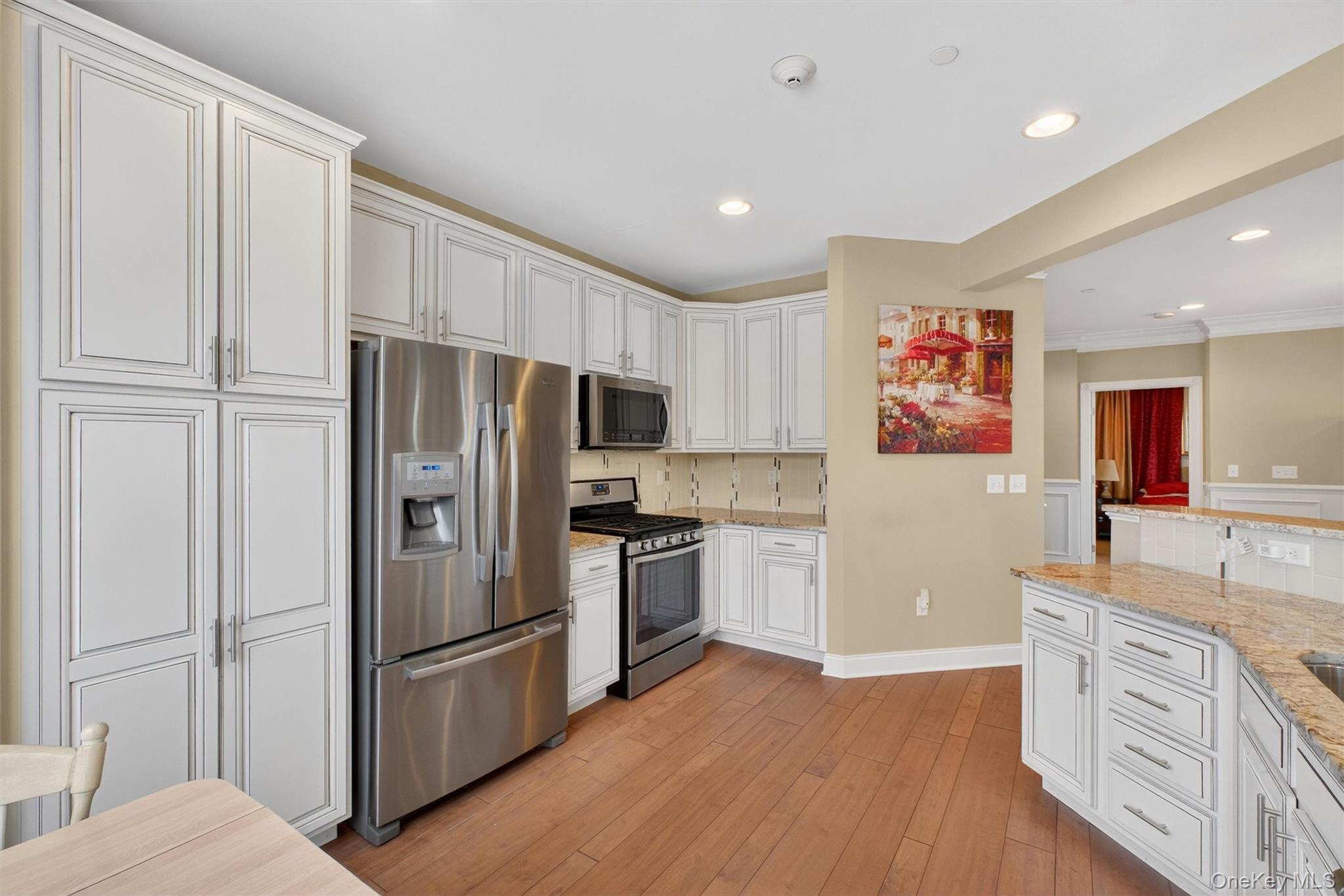 734 Regency Drive Fishkill, NY 12524 - Photo 11 of 45 a kitchen with a refrigerator cabinets and wooden floor