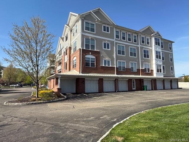 734 Regency Drive Fishkill, NY 12524 - Photo 26 of 45 a front view of a building with a garden
