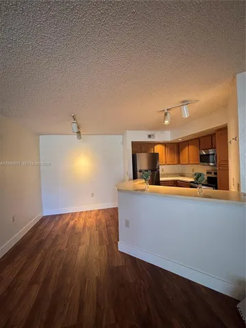 a view of kitchen and wooden floor
