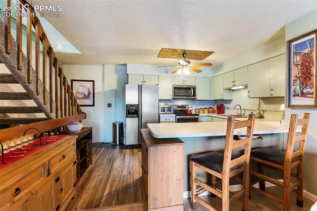 a view of kitchen with cabinets and wooden floor