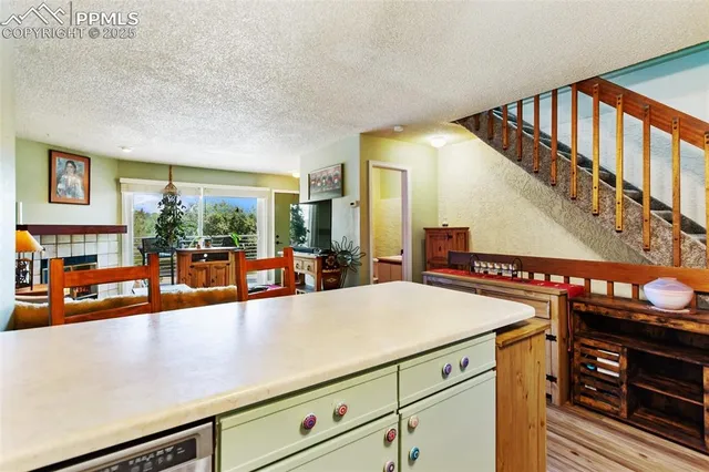 a view of a living room and entryway with a table and chairs