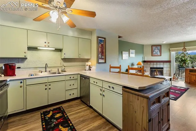 a kitchen with a stove cabinets and wooden floor