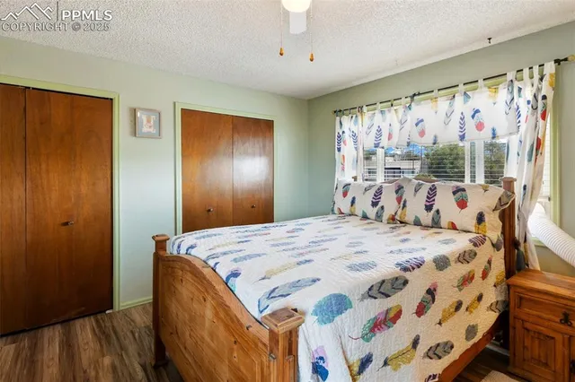 a bed sitting in a bedroom next to a window