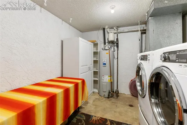 a bedroom with a bed and a refrigerator