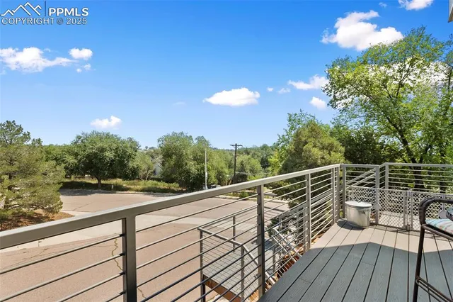 a view of balcony with wooden floor and fence