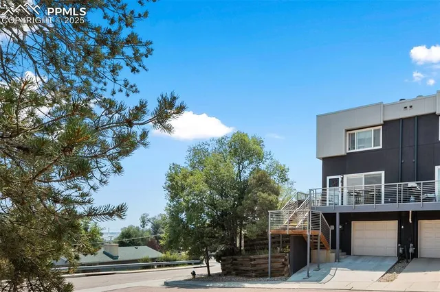 a view of a terrace with a bench and trees around