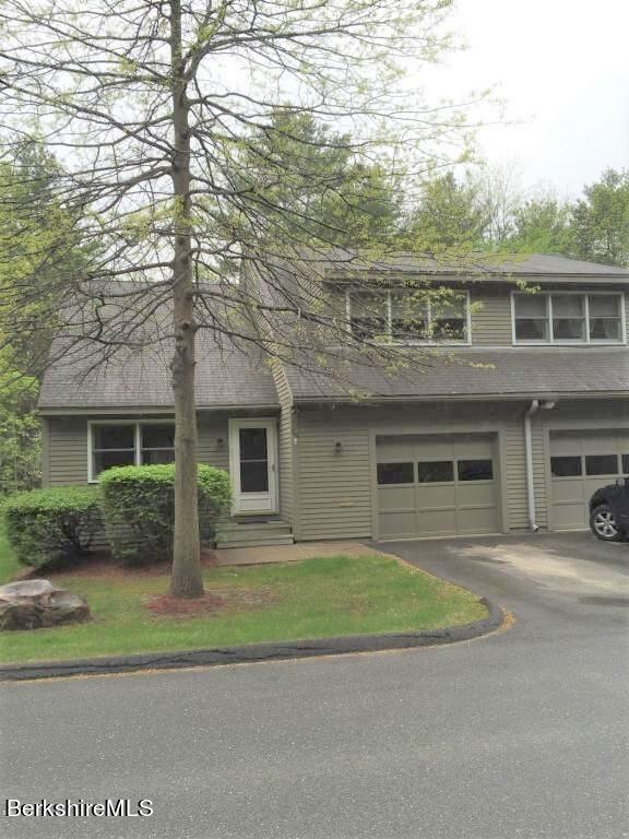 751 Mohawk Trail, Unit 1D North Adams, MA 01247 - Photo 2 of 32 a front view of a house with a garden and garage