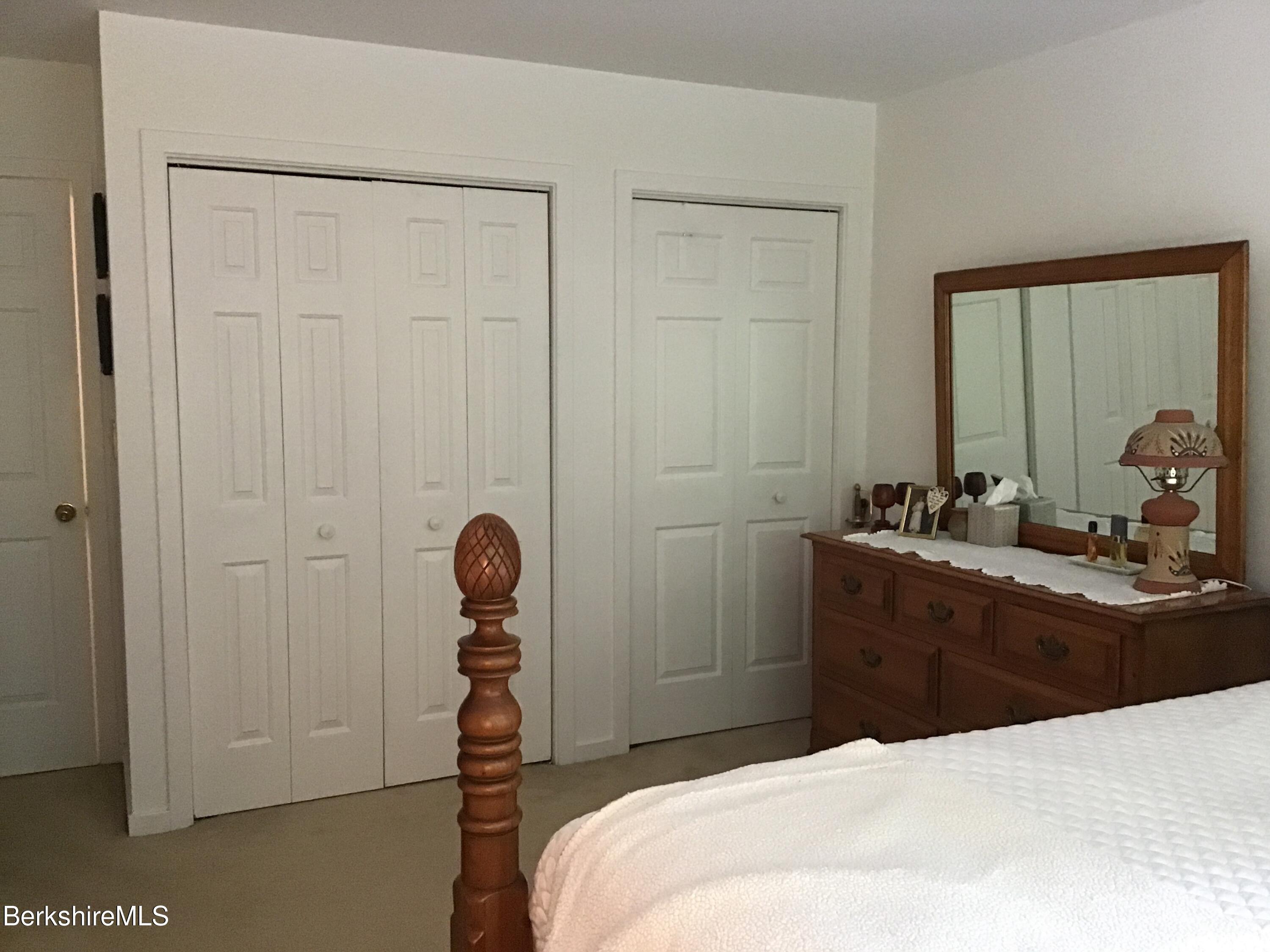 751 Mohawk Trail, Unit 1D North Adams, MA 01247 - Photo 21 of 32 a bedroom with a bed and a table