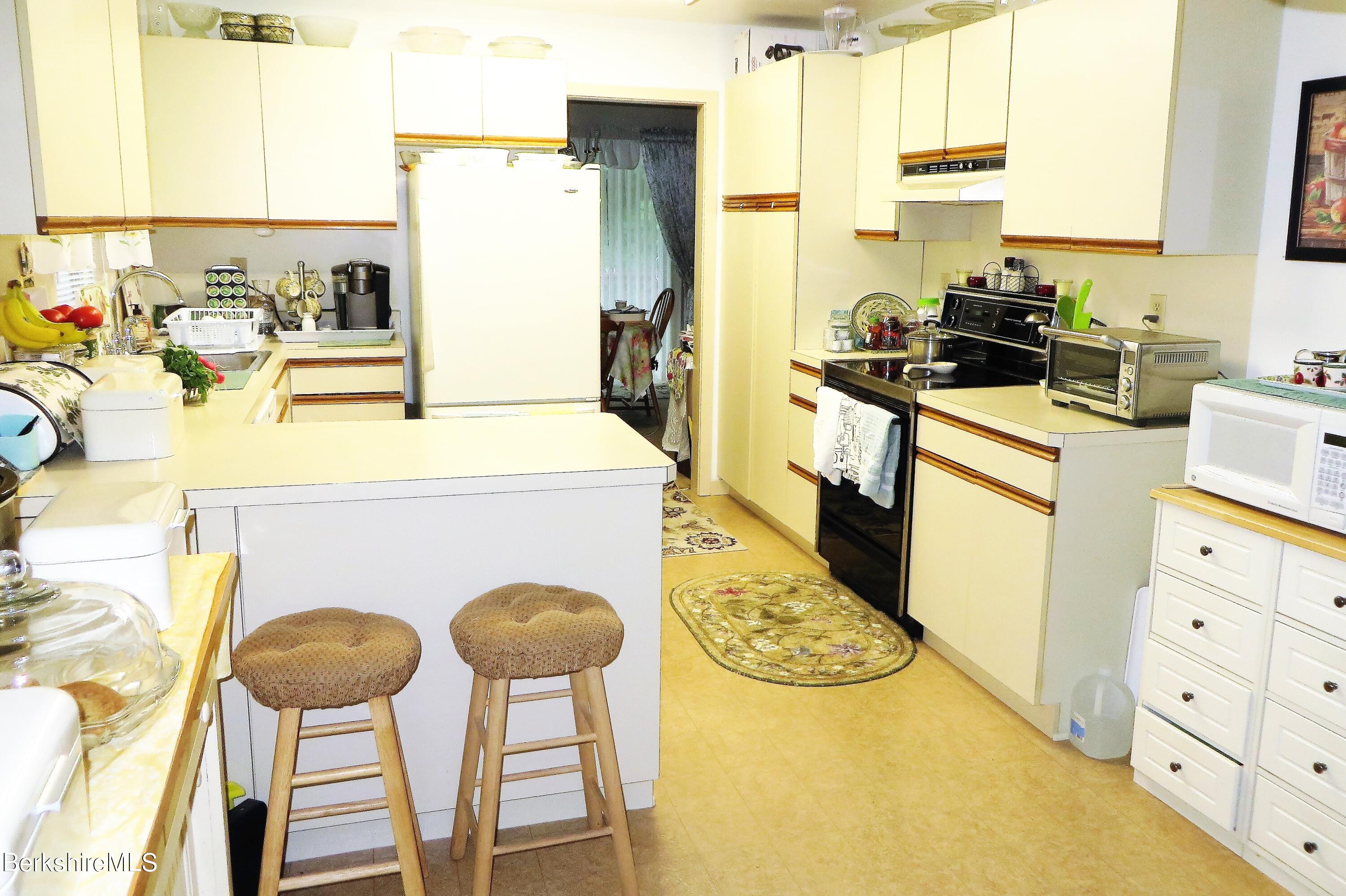 751 Mohawk Trail, Unit 1D North Adams, MA 01247 - Photo 4 of 32 a kitchen with table and chairs