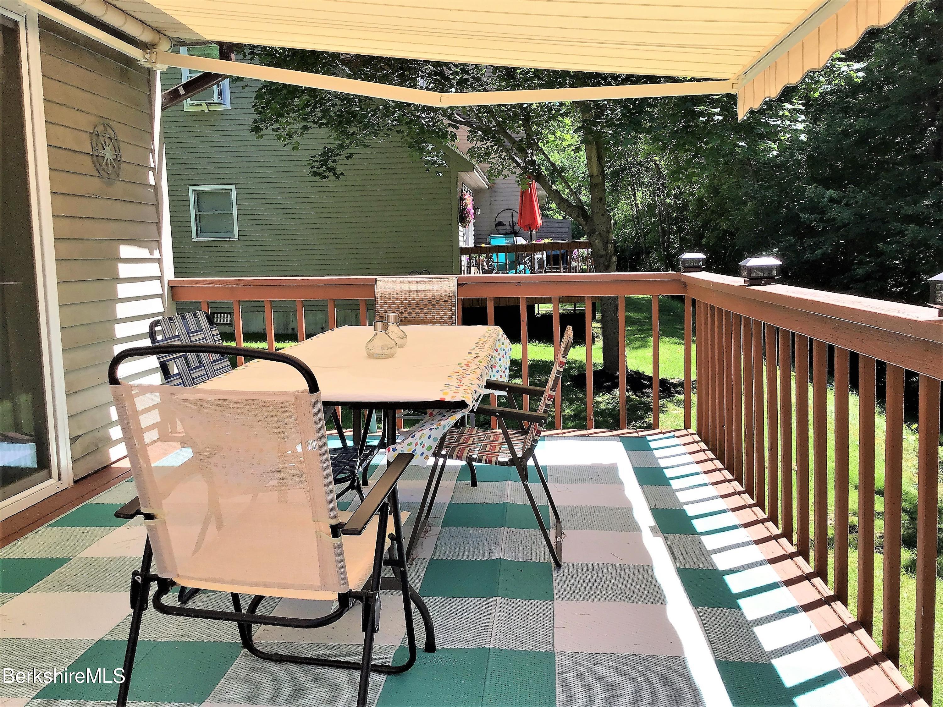 751 Mohawk Trail, Unit 1D North Adams, MA 01247 - Photo 32 of 32 a view of a patio with table and chairs with wooden floor and fence