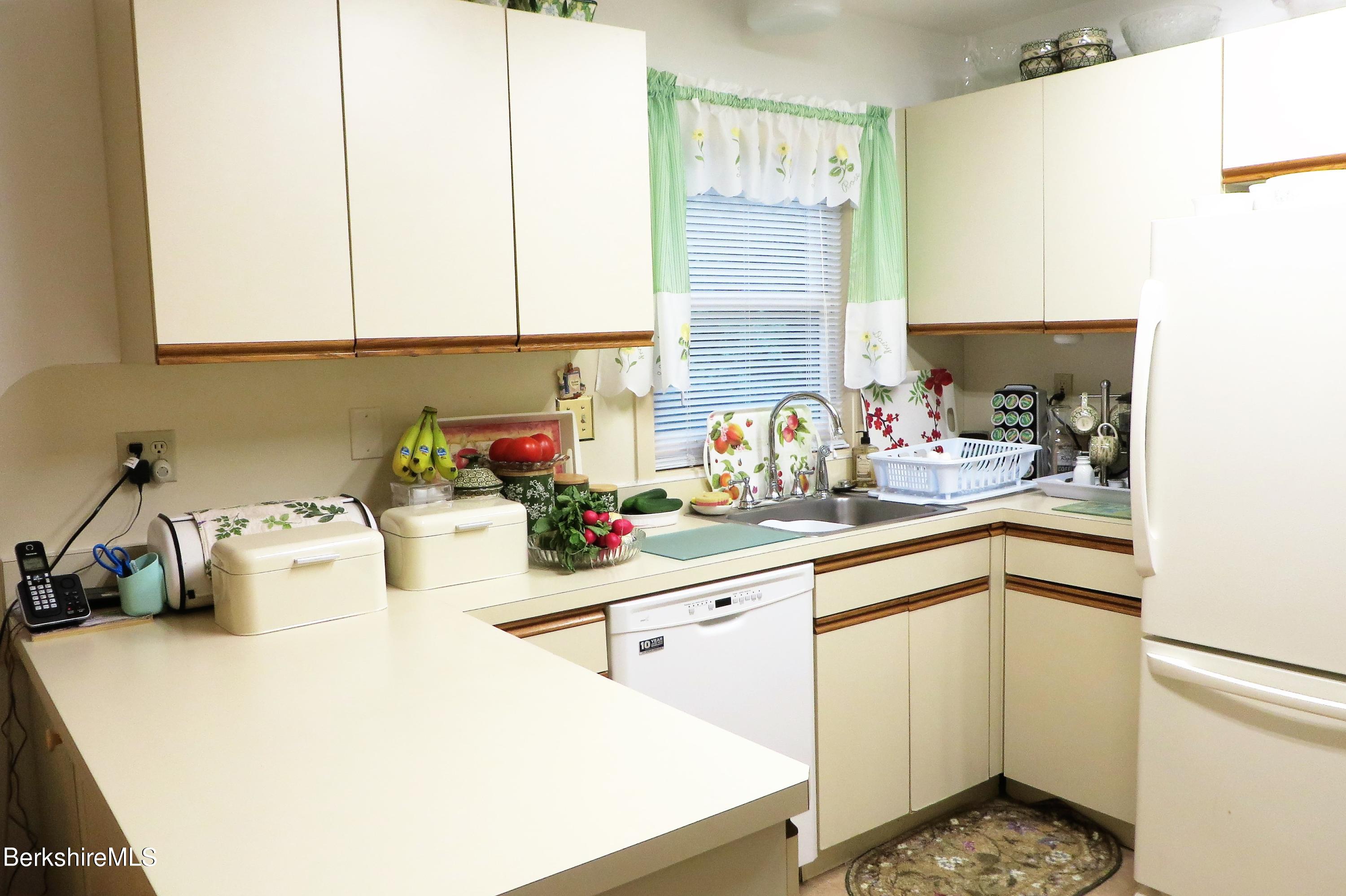751 Mohawk Trail, Unit 1D North Adams, MA 01247 - Photo 8 of 32 a kitchen with a sink stove and cabinets