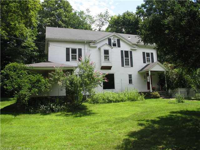 142 Ansonia Road Woodbridge, CT 06525 - Photo 1 of 1 a front view of a house with a yard and trees